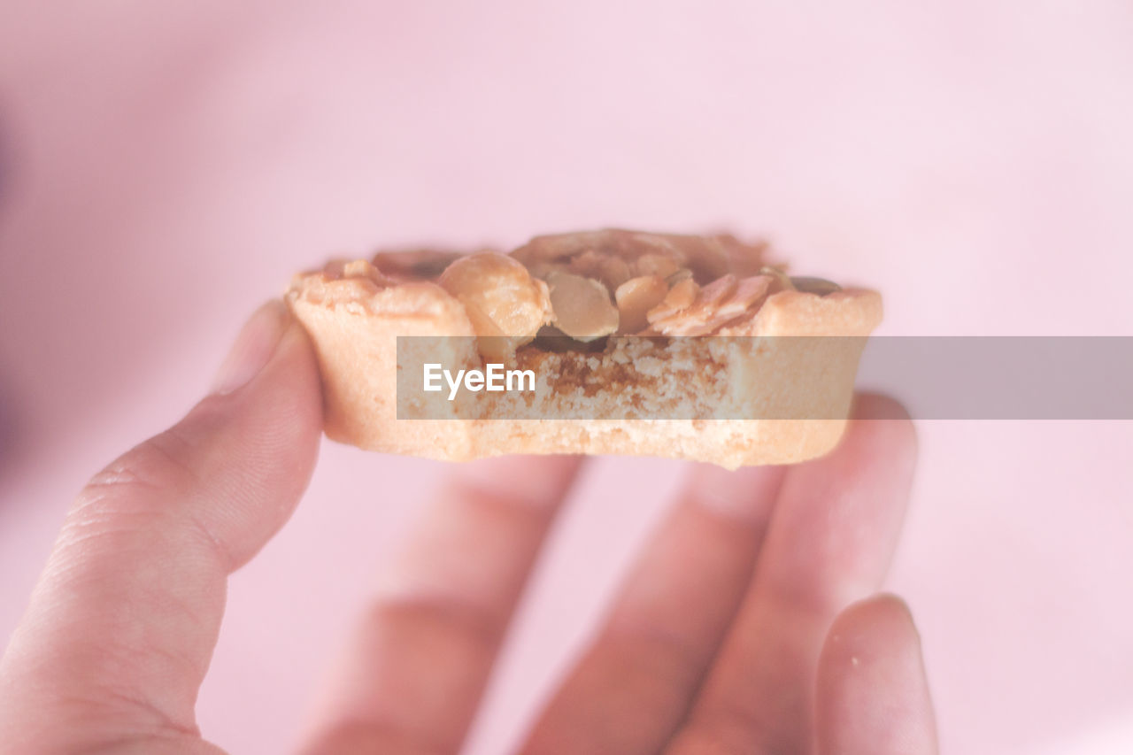 Close-up of hand holding cookie