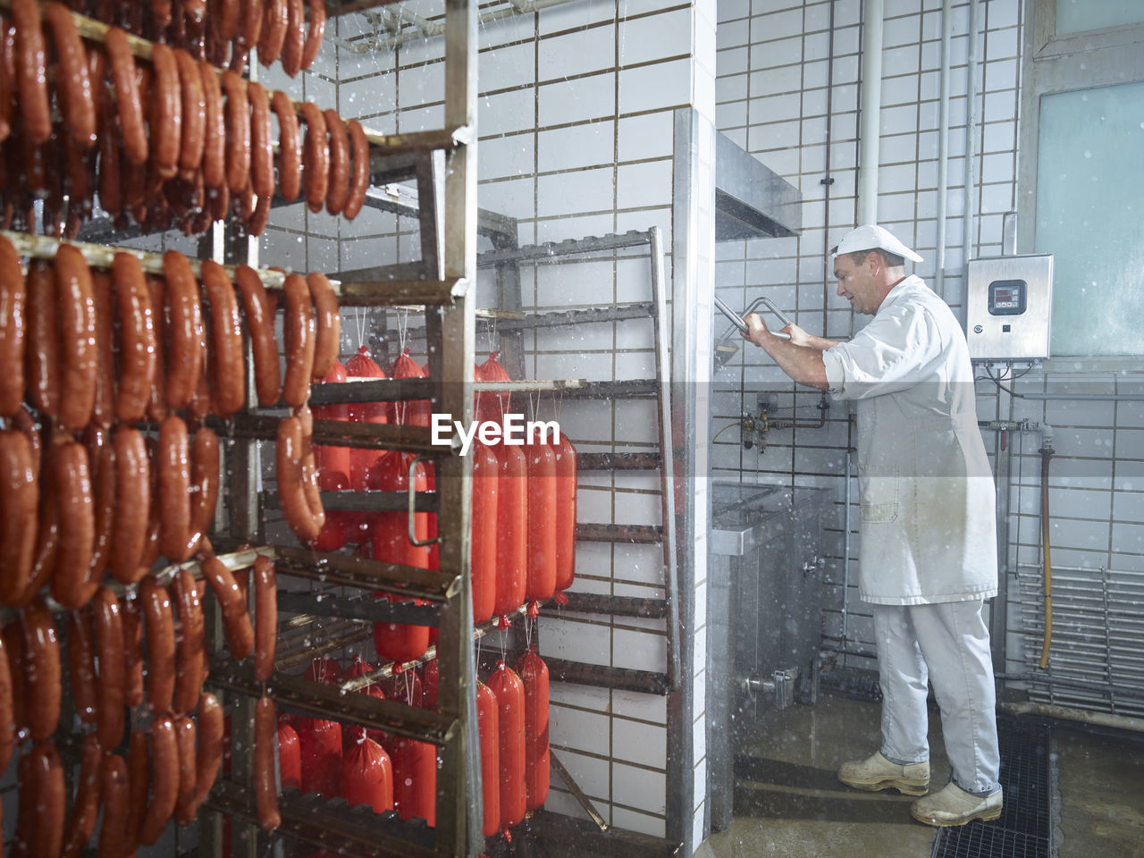 Butcher washing machinery with water in factory