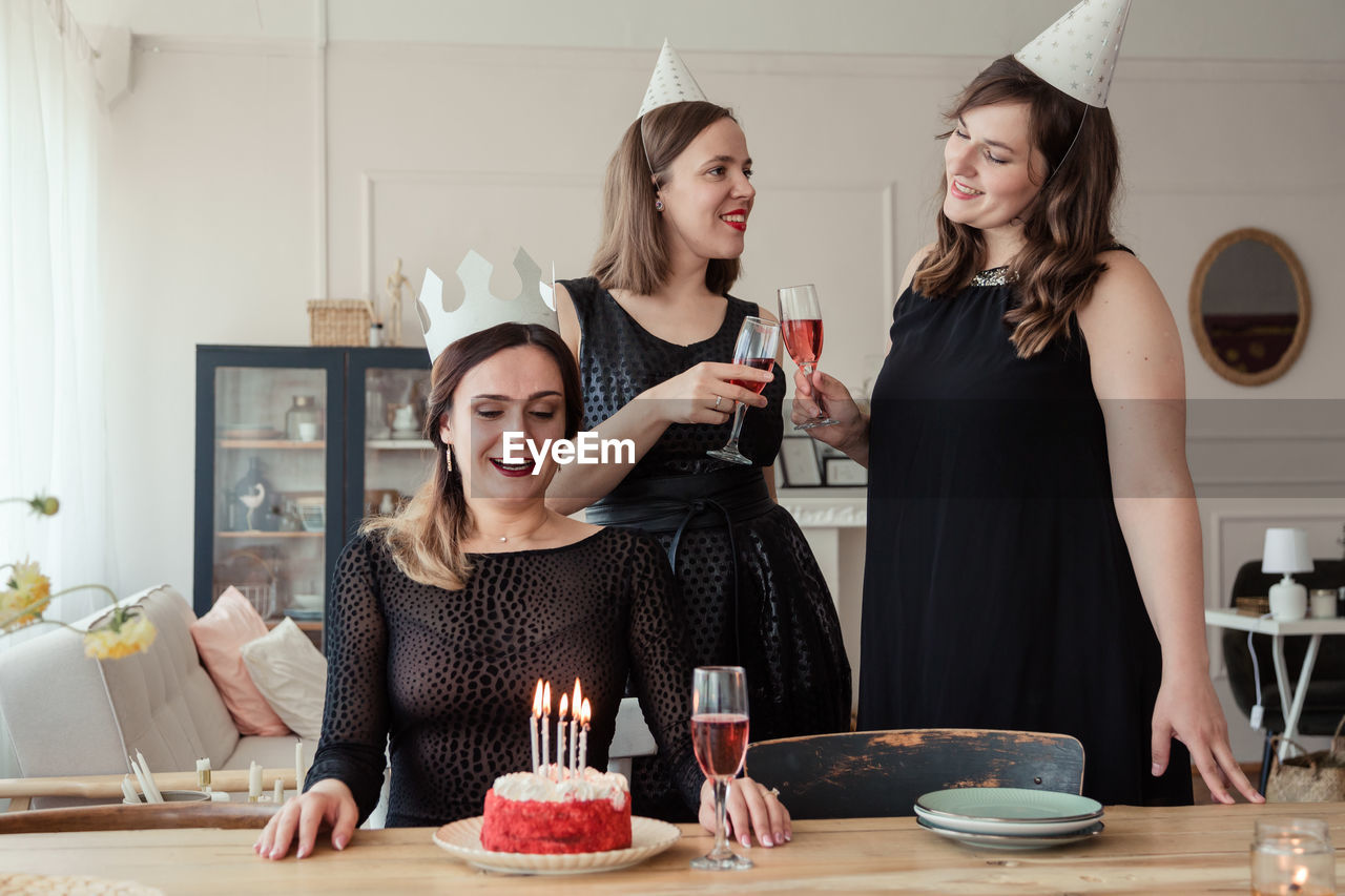 Happy women celebrating birthday at home