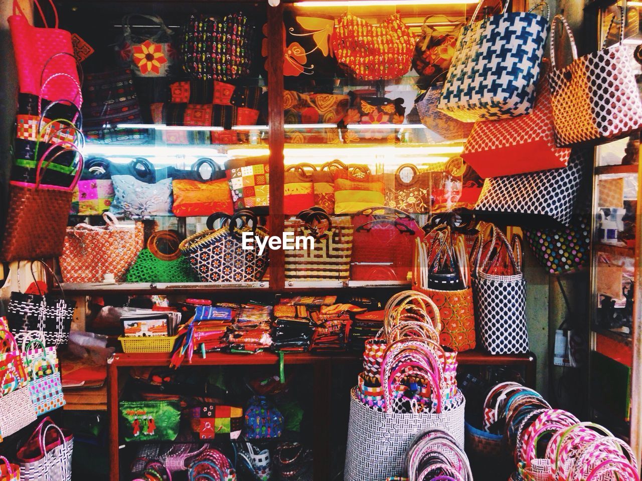 Large group of handbags displayed for sale