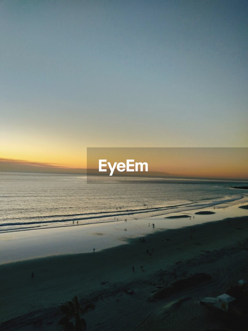 Scenic view of beach against sky during sunset