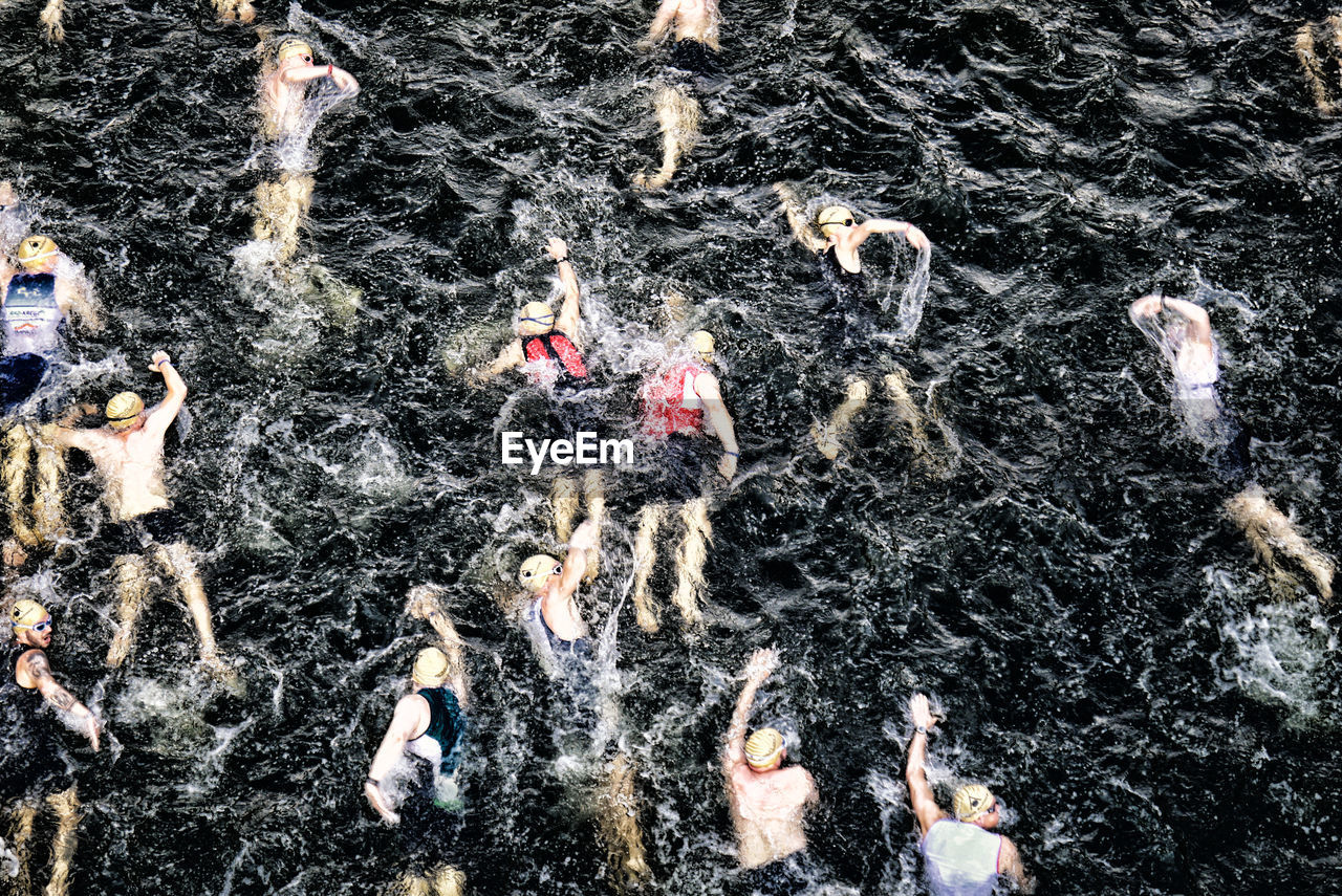 High angle view of triathletes swimming in spree river during triathlon