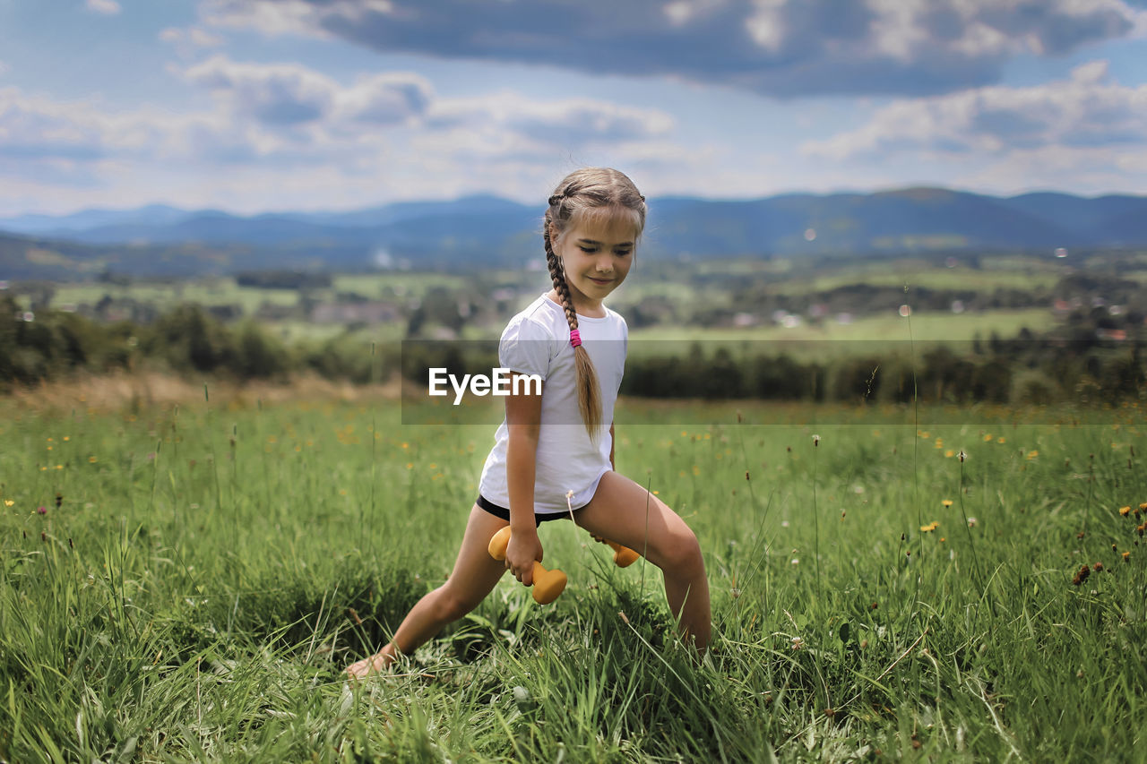 Full length of boy on field against sky