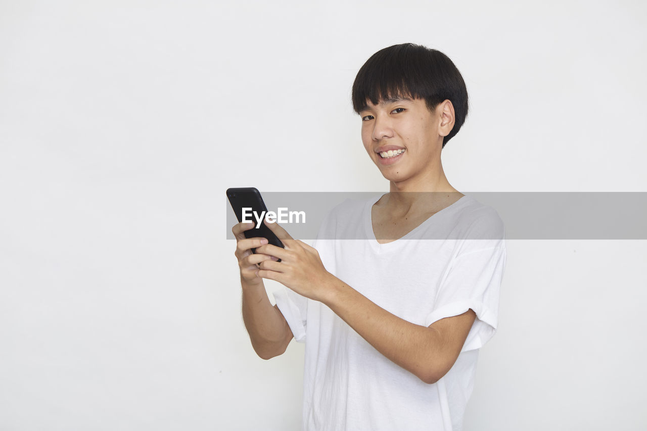 YOUNG MAN USING MOBILE PHONE