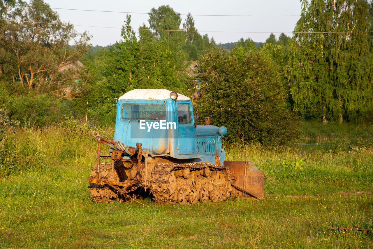 abandoned car on grassy field