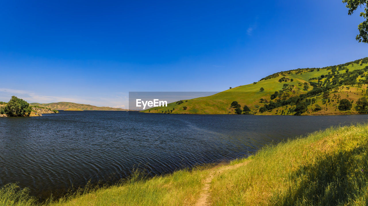 scenic view of mountains against clear blue sky