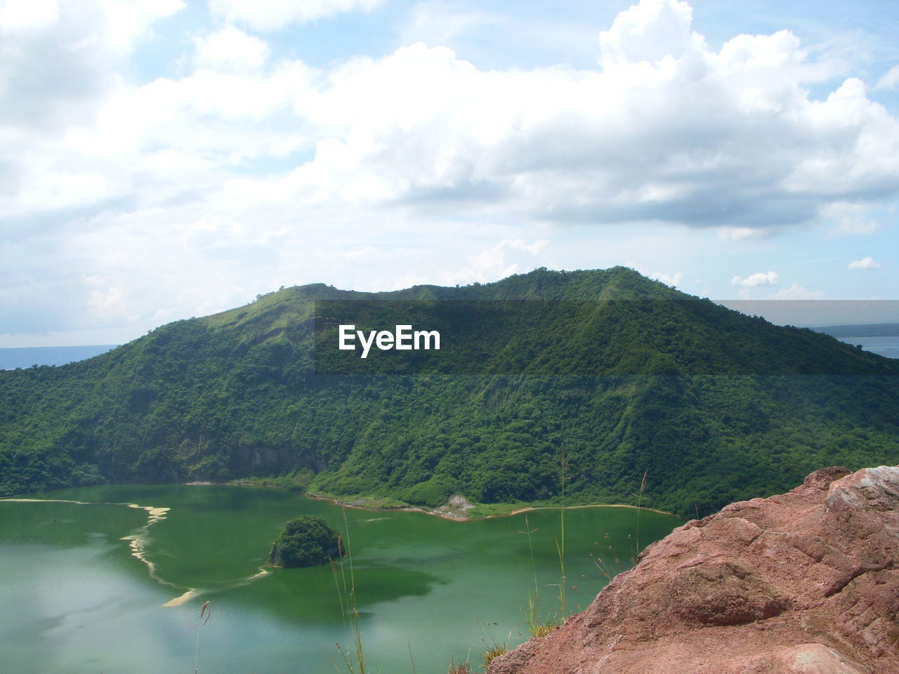 Scenic view of lake and mountains against sky