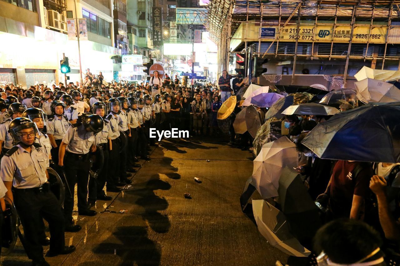Group of people and police officers on street