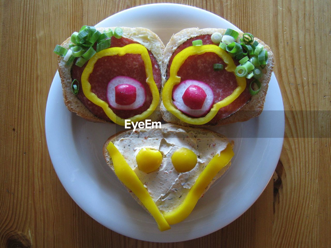 High angle view of anthropomorphic face made from bread and vegetables