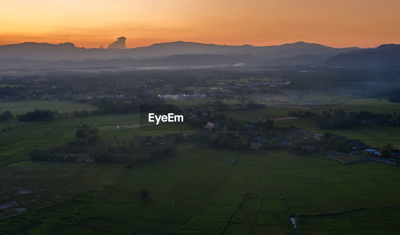 SCENIC VIEW OF FIELD AGAINST SKY AT SUNSET