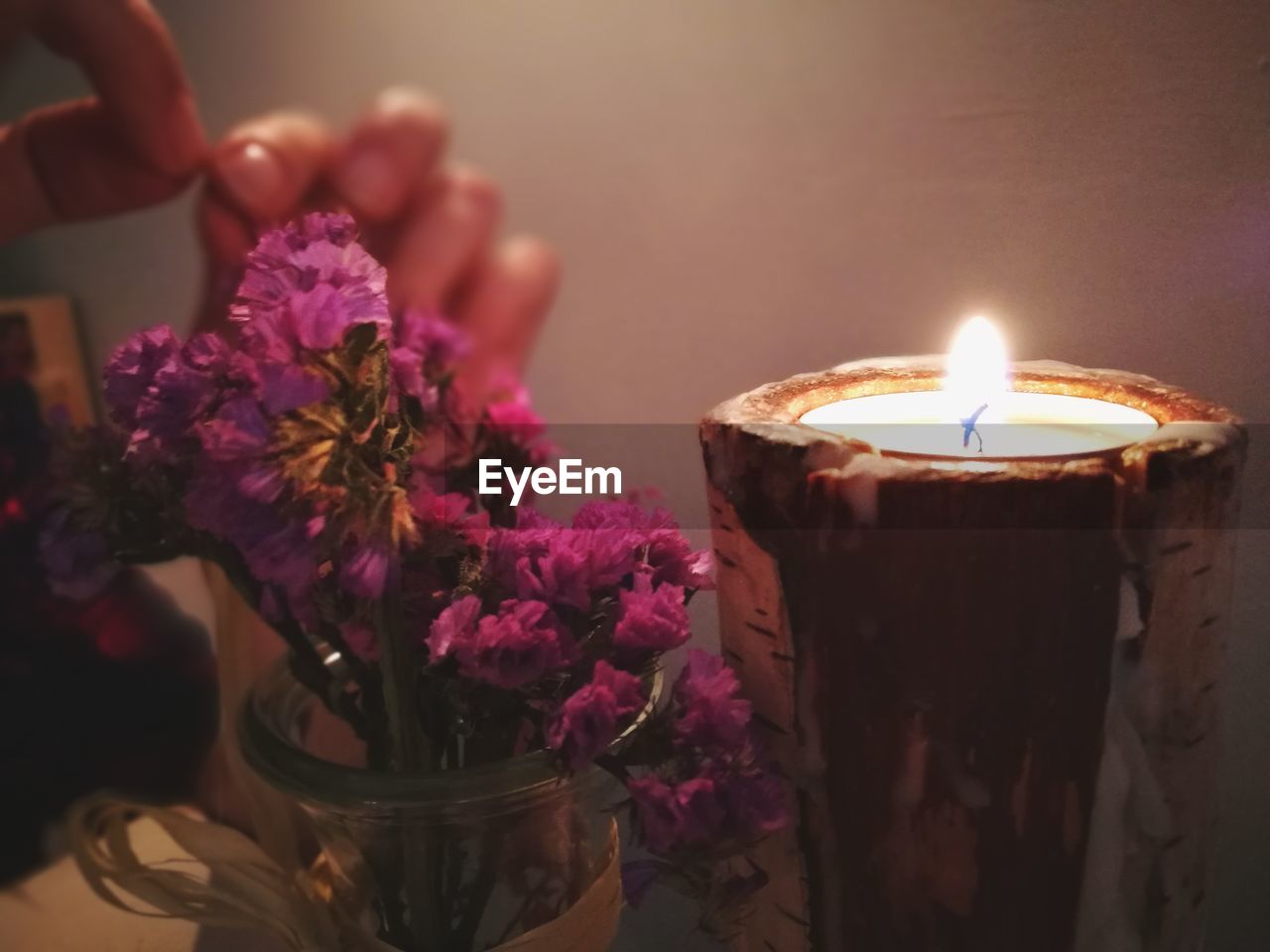 CLOSE-UP OF ILLUMINATED FLOWER POT ON TABLE