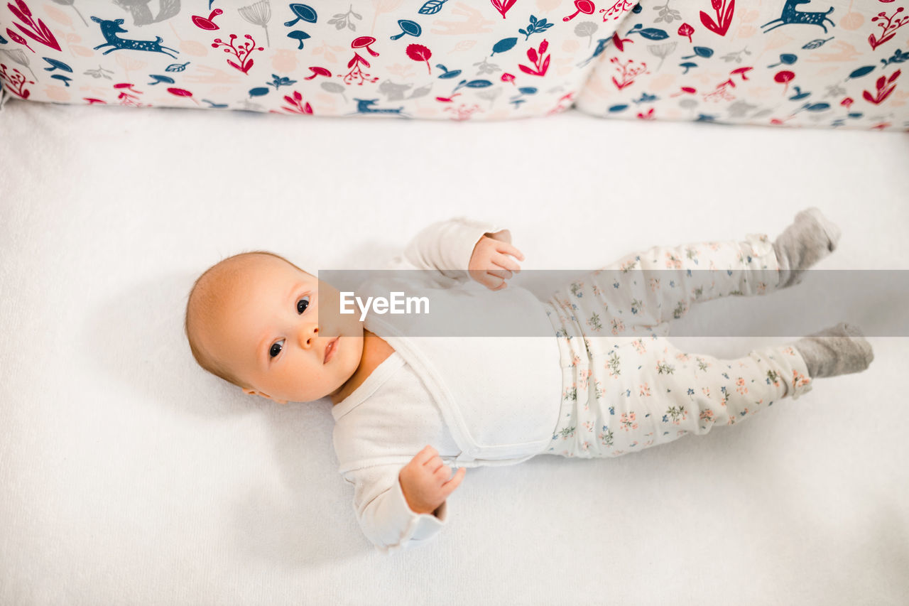 High angle view of girl sleeping on bed