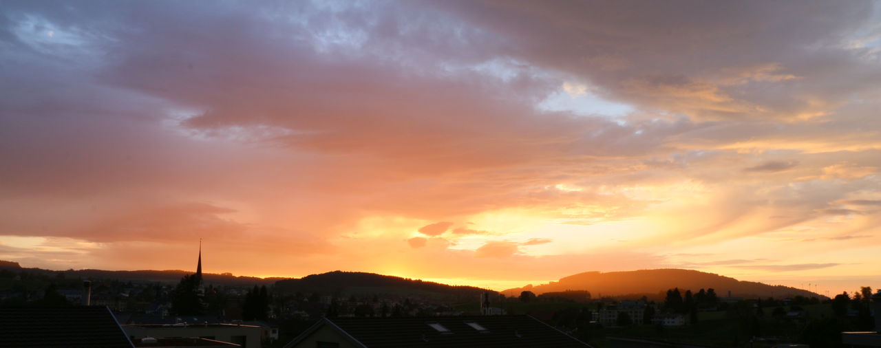 SUN SHINING THROUGH CLOUDS