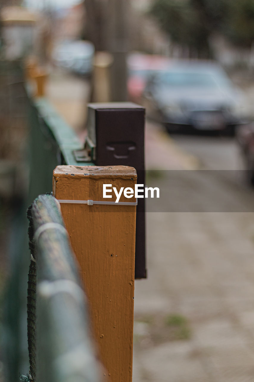 CLOSE-UP OF PADLOCK ON WOODEN FENCE