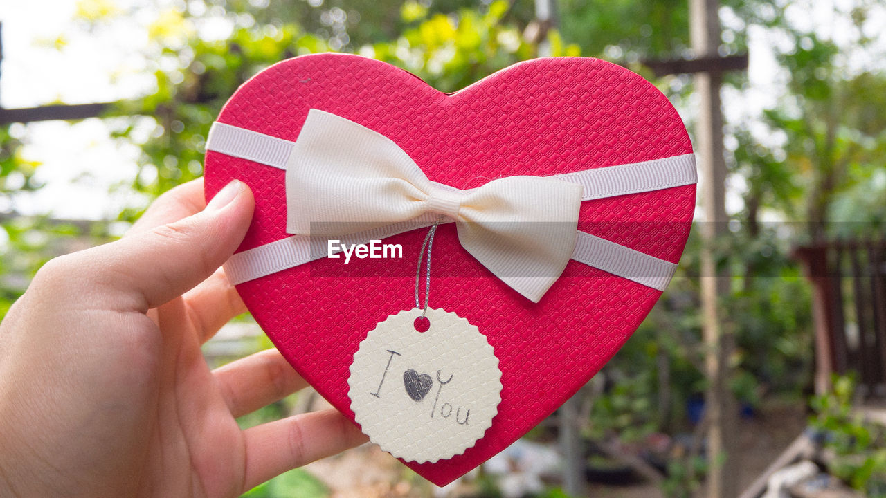 Cropped hand of woman holding heart shape