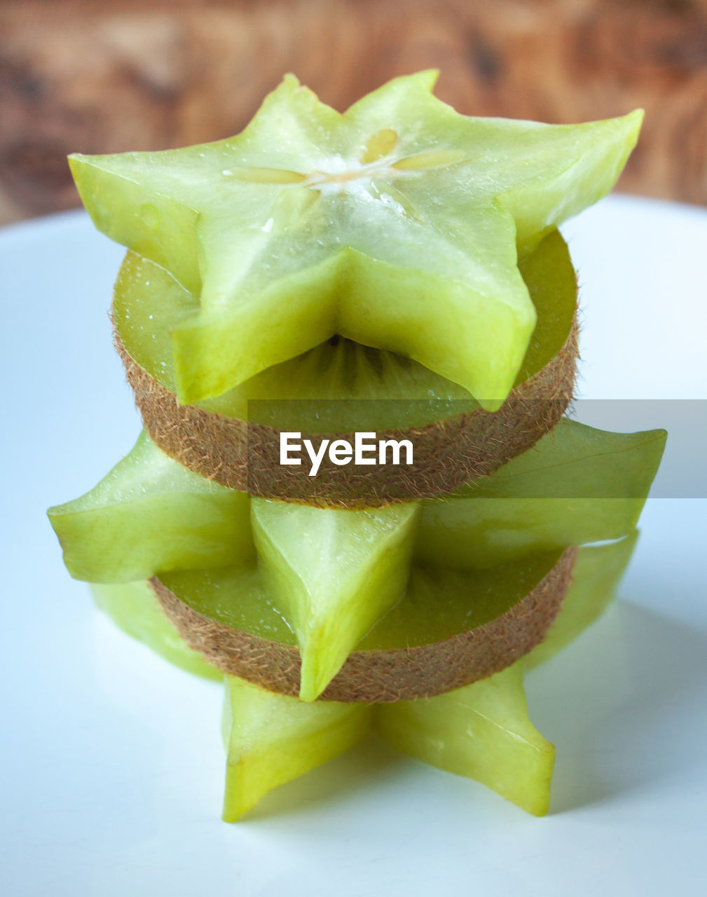 Close-up of starfruits and kiwis in plate