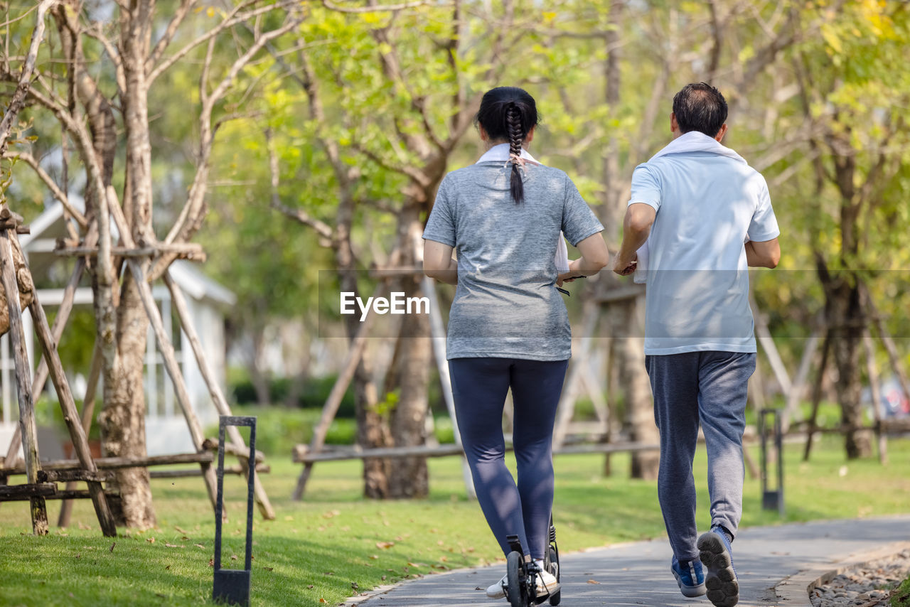 Couple workout and exercise with scooter together outdoor in park person