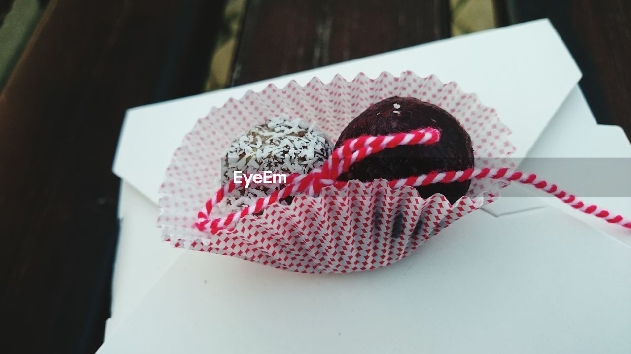 Close-up of desserts with martenitsa in cupcake holder during baba marta day