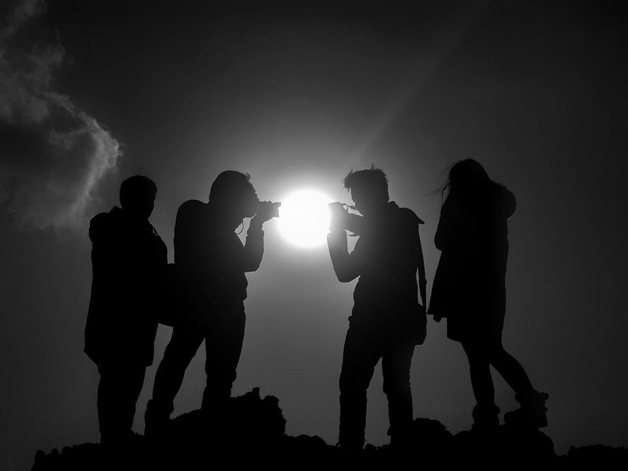 SILHOUETTE MEN PHOTOGRAPHING AGAINST SKY