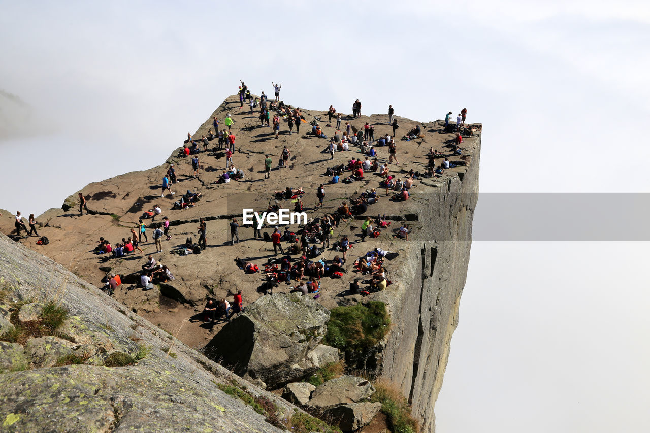 High angle view of people on preikestolen during foggy weather