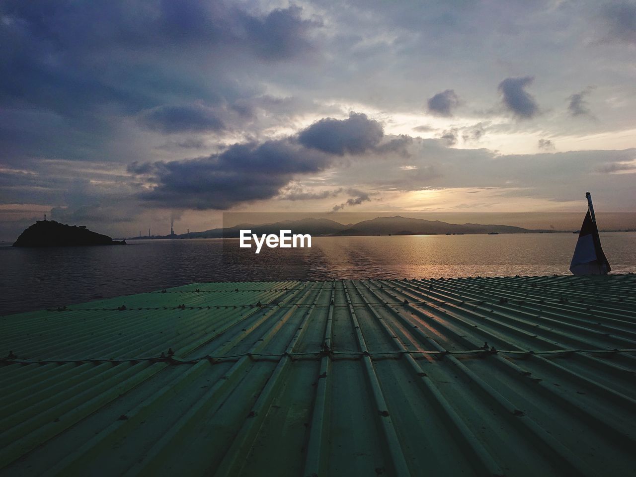 sky, horizon, water, sunlight, sea, cloud, nature, sunset, environment, ocean, land, beauty in nature, architecture, scenics - nature, travel, travel destinations, landscape, transportation, nautical vessel, beach, pier, dusk, sun, outdoors, coast, holiday, no people, tranquility, tourism, evening, vacation, trip, built structure, horizon over water, reflection, tranquil scene, blue, shore