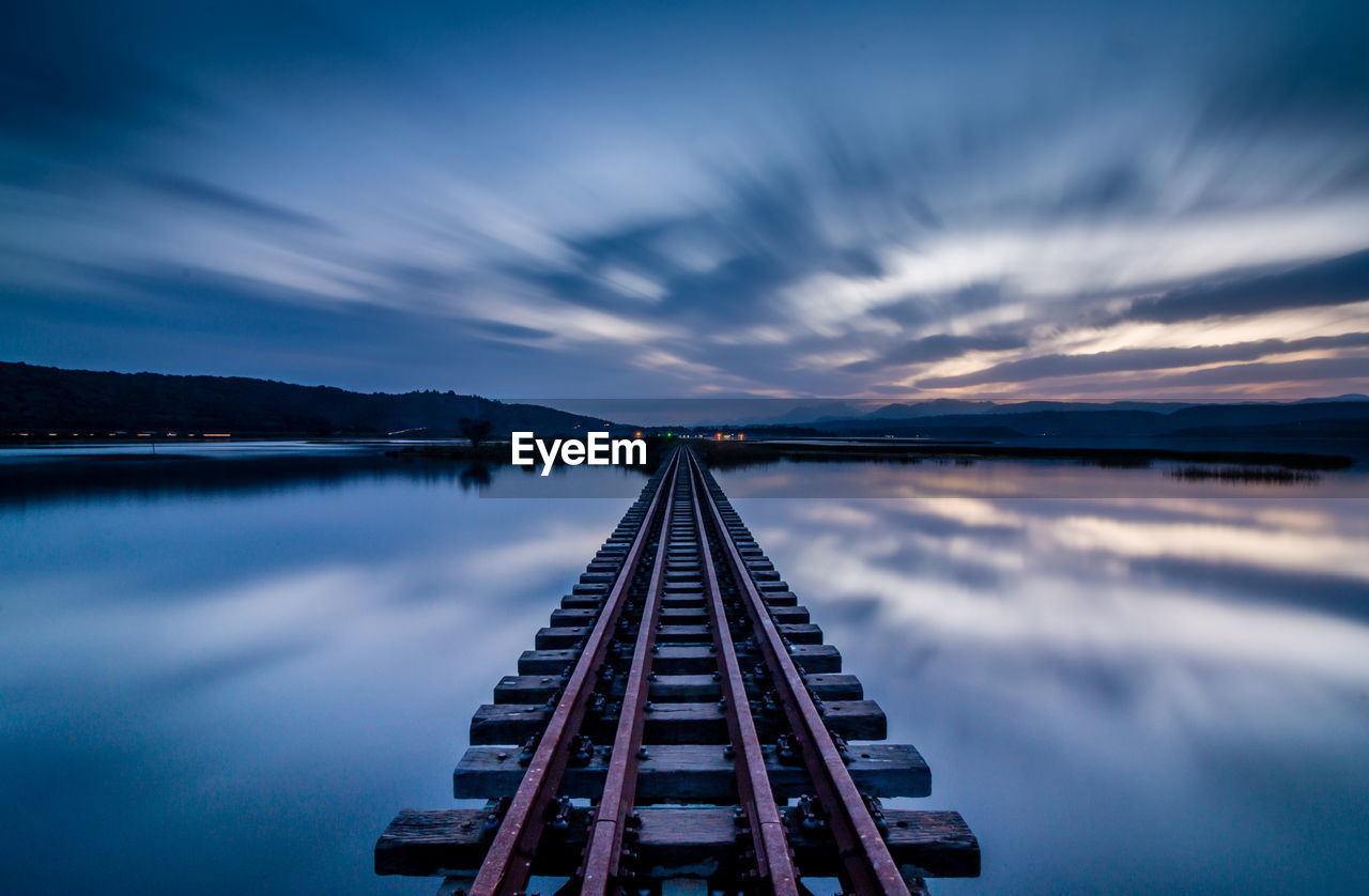 Scenic view of lake against sky at sunset