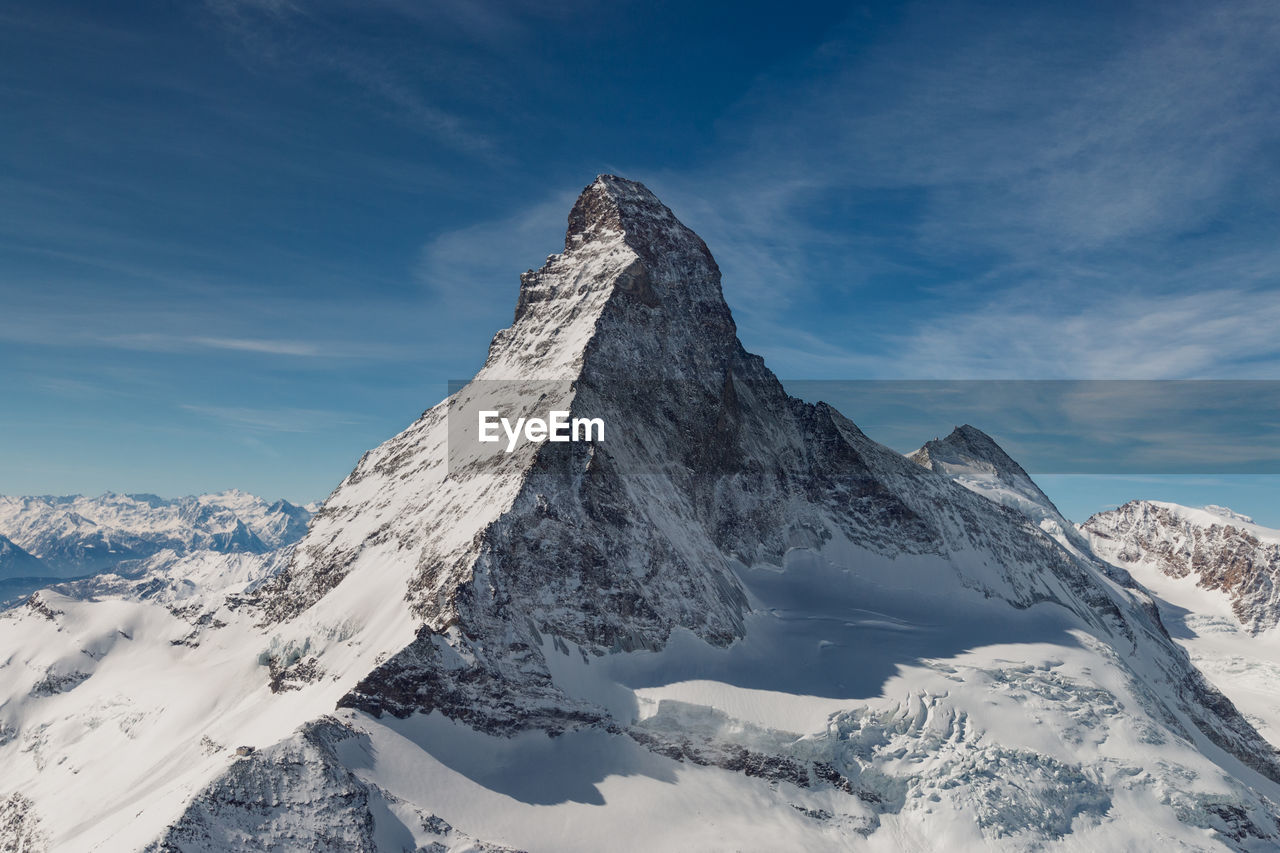 Scenic view of snow covered mountains against sky