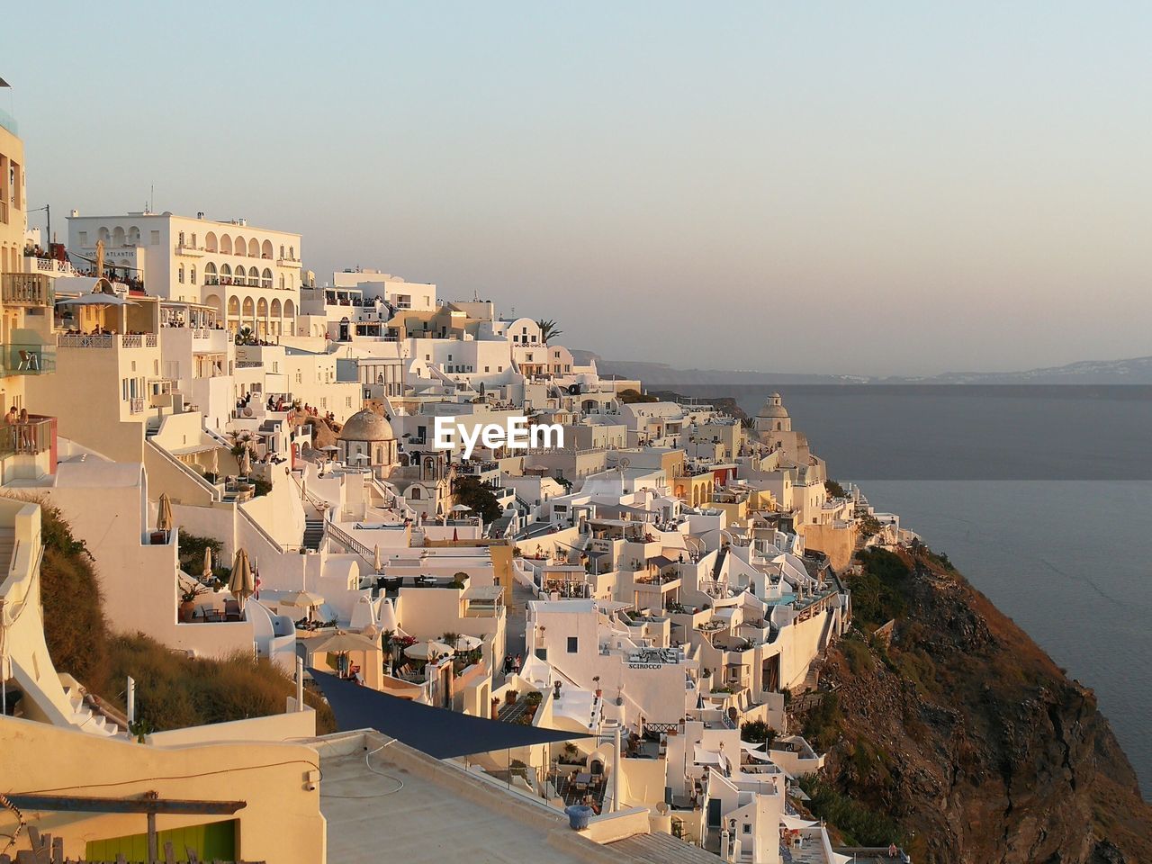 High angle view of town by sea against clear sky