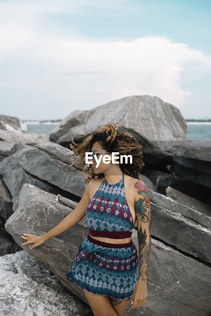 Woman standing on rock at beach