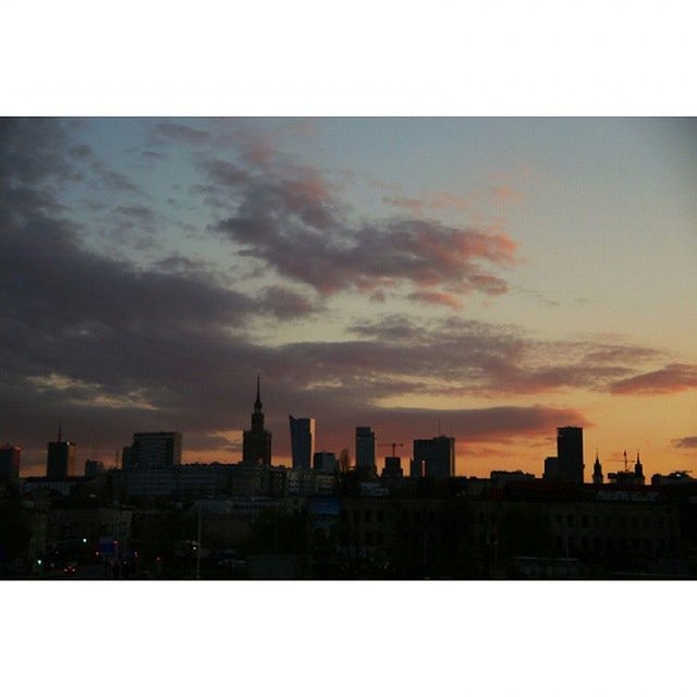 SKYSCRAPERS IN CITY AT SUNSET