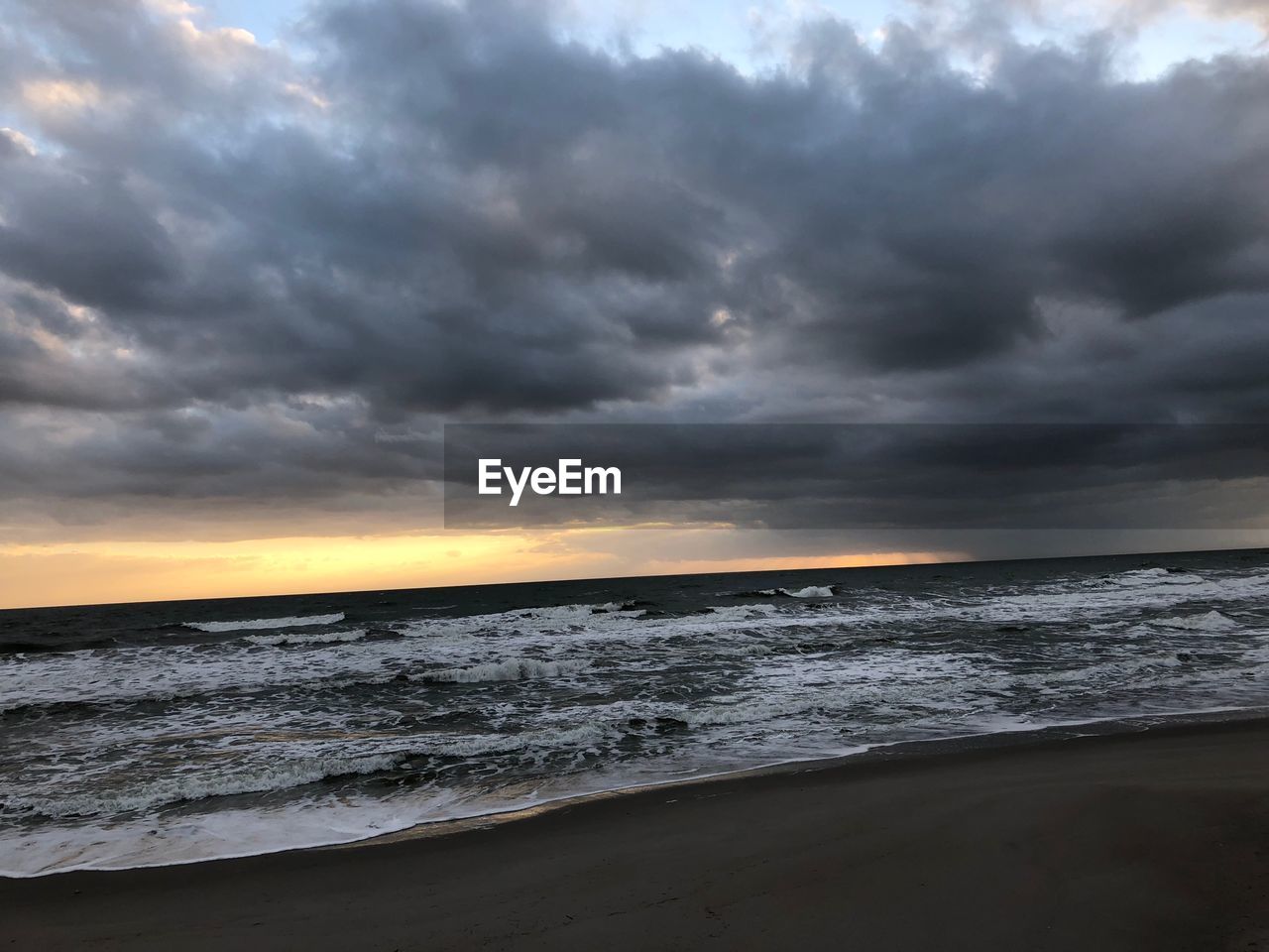 SCENIC VIEW OF SEA AGAINST STORM CLOUDS