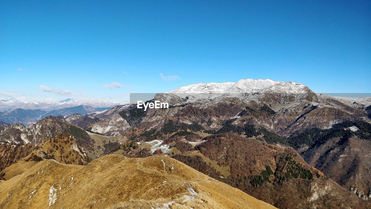 Scenic view of mountains against clear blue sky