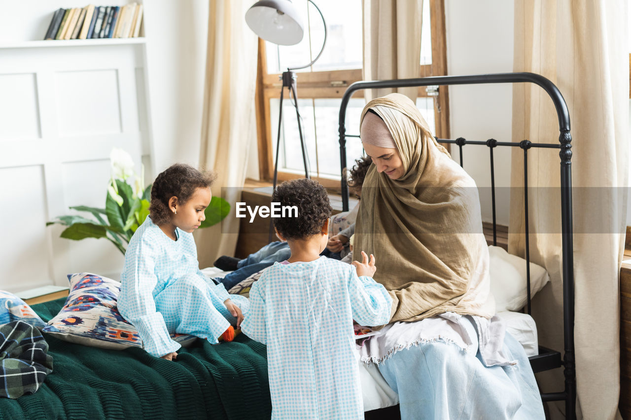 Family on bed at home