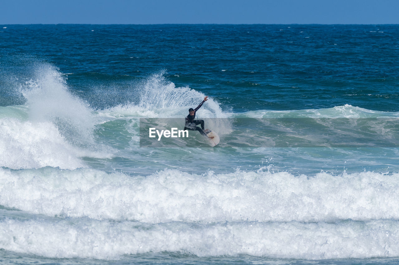 man surfing on sea