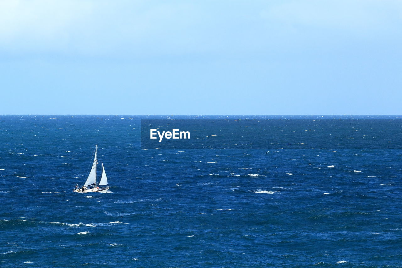 High angle view of sailboat sailing in sea against sky