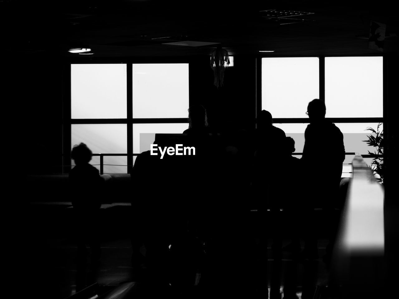 SILHOUETTE PEOPLE STANDING IN CORRIDOR