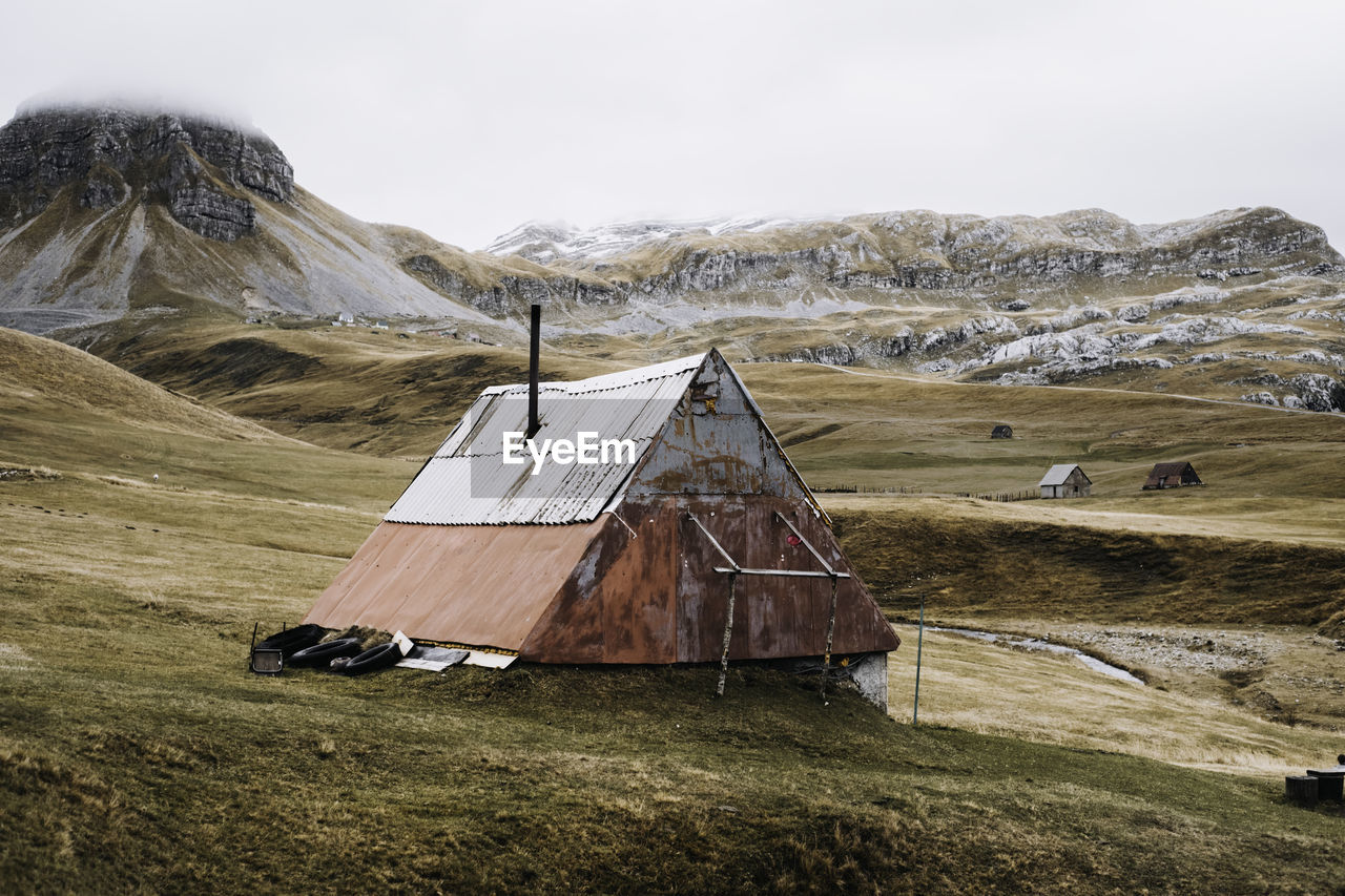 Isolated house on field against sky