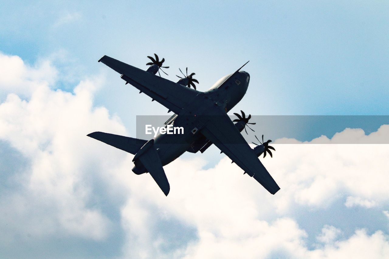 Low angle view of airplane flying in sky