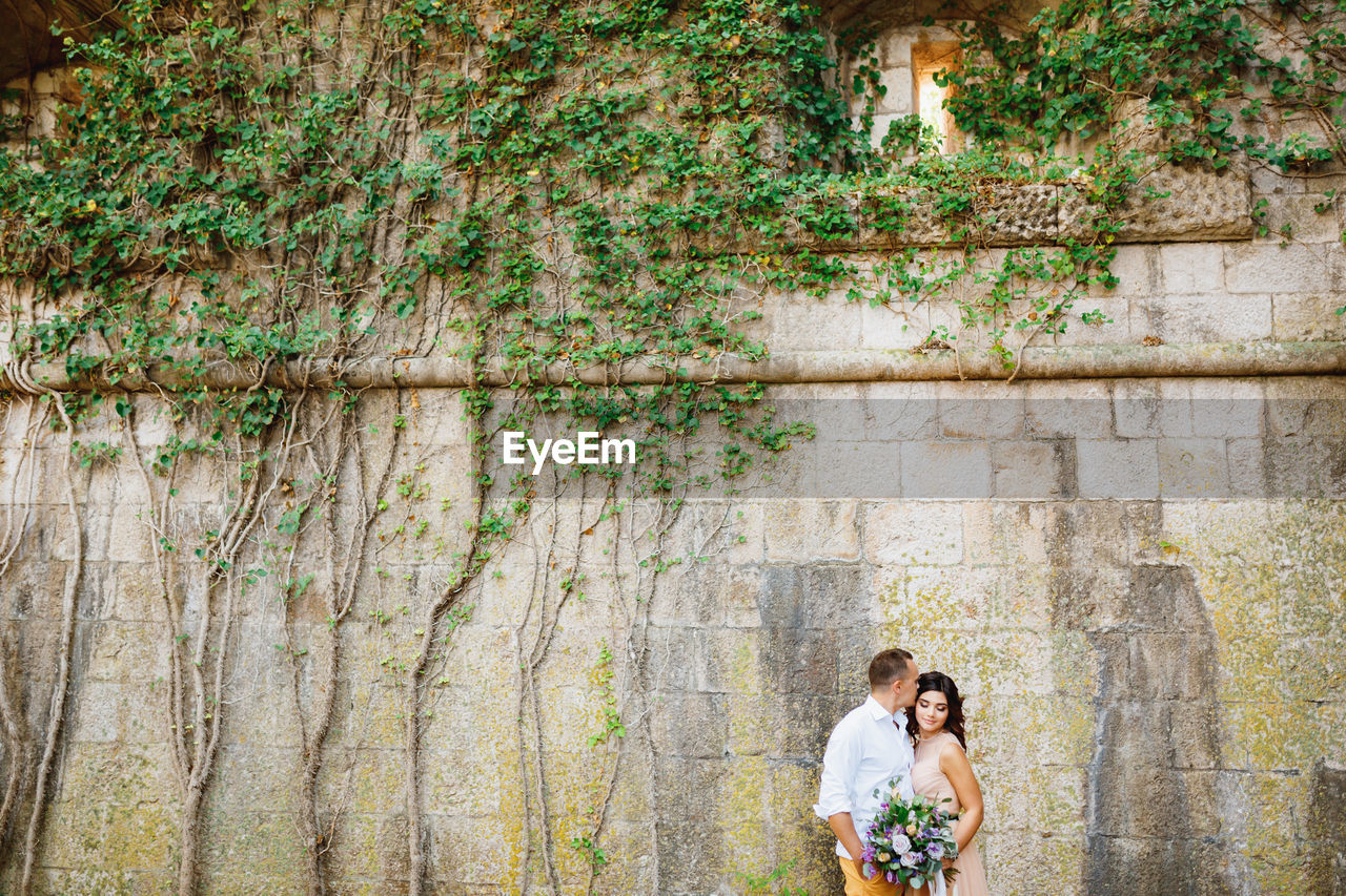 Couple standing near wall