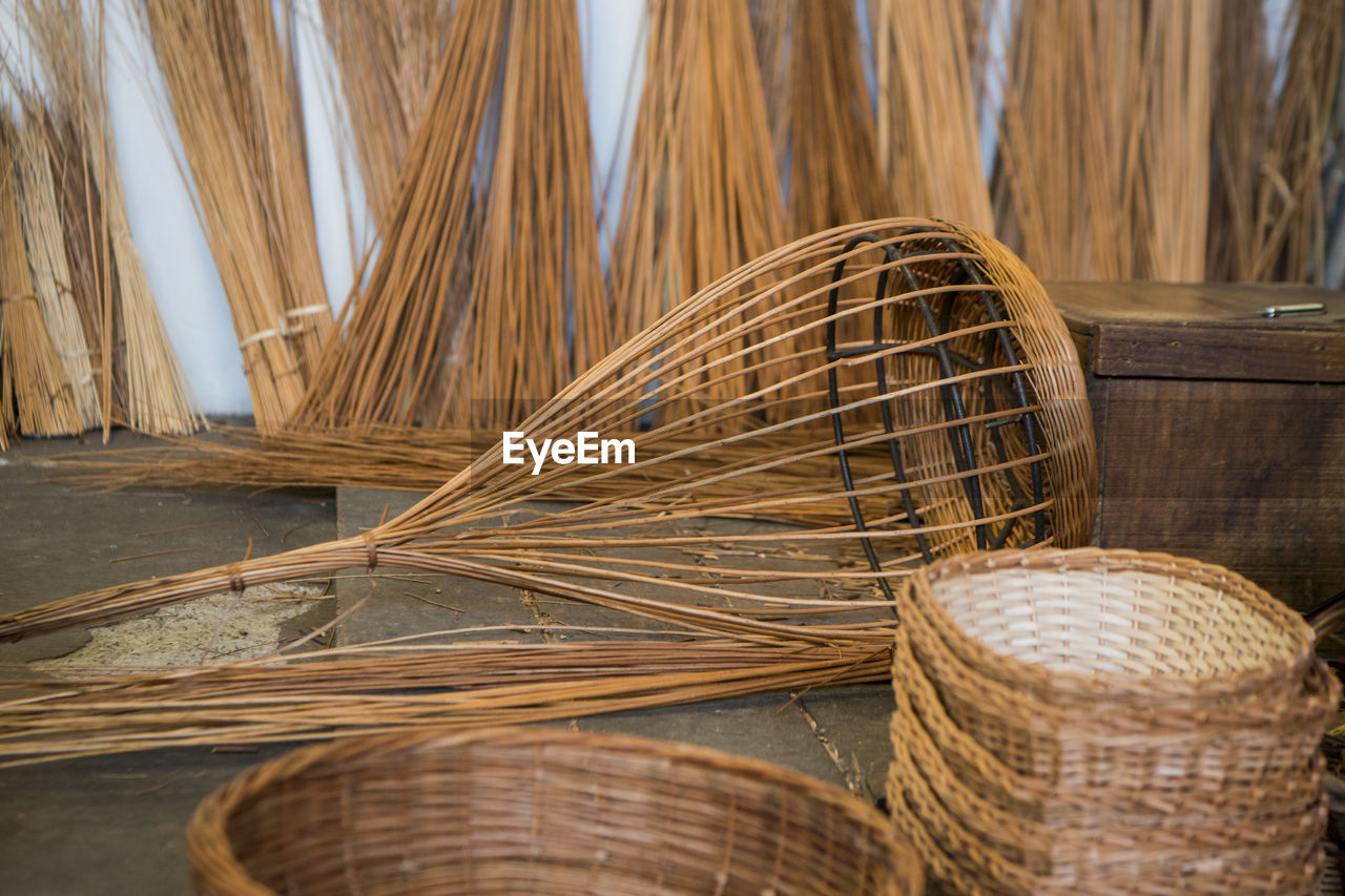 CLOSE-UP OF WICKER BASKET ON WOOD