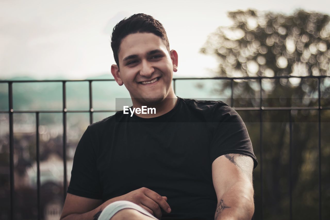 Portrait of smiling man sitting outdoors