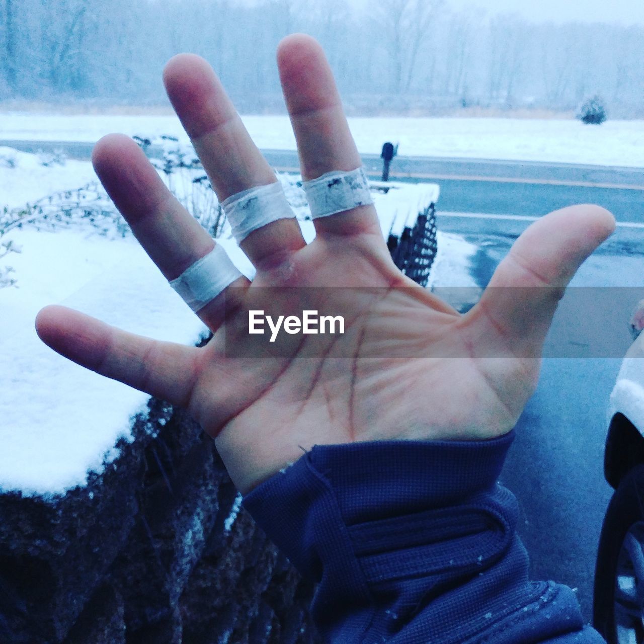 Cropped hand with bandage during winter