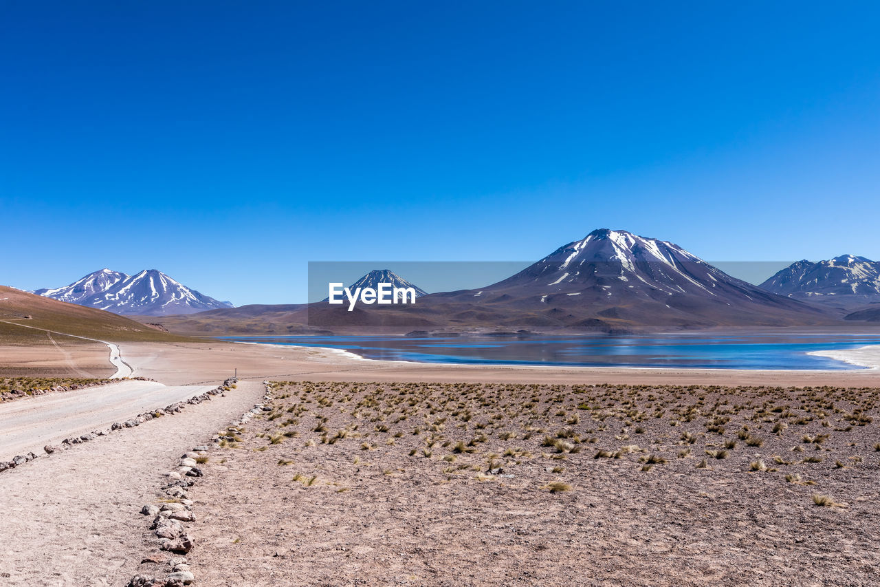 SCENIC VIEW OF ARID LANDSCAPE AGAINST CLEAR BLUE SKY