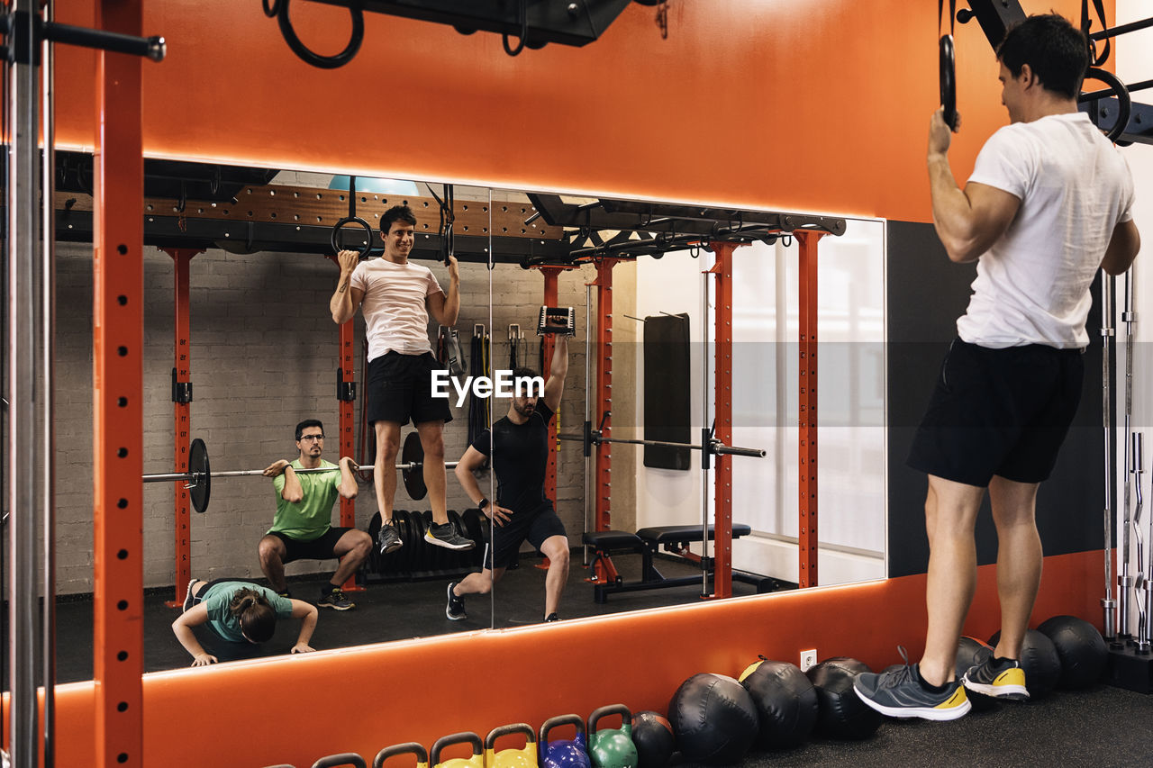 Group of beginners athletes exercising in a personal class with a private trainer. various exercises