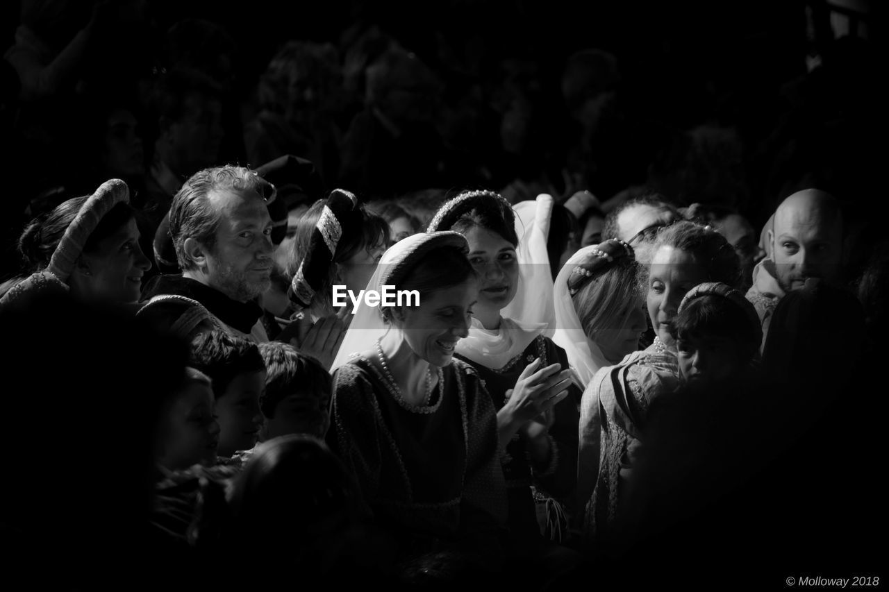 GROUP OF PEOPLE LOOKING AT CONCERT