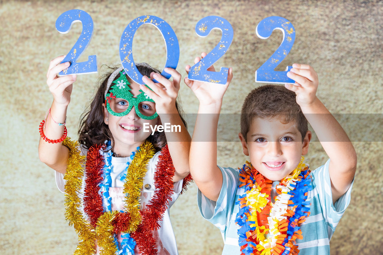 Three kids celebrating new years eve. 2022