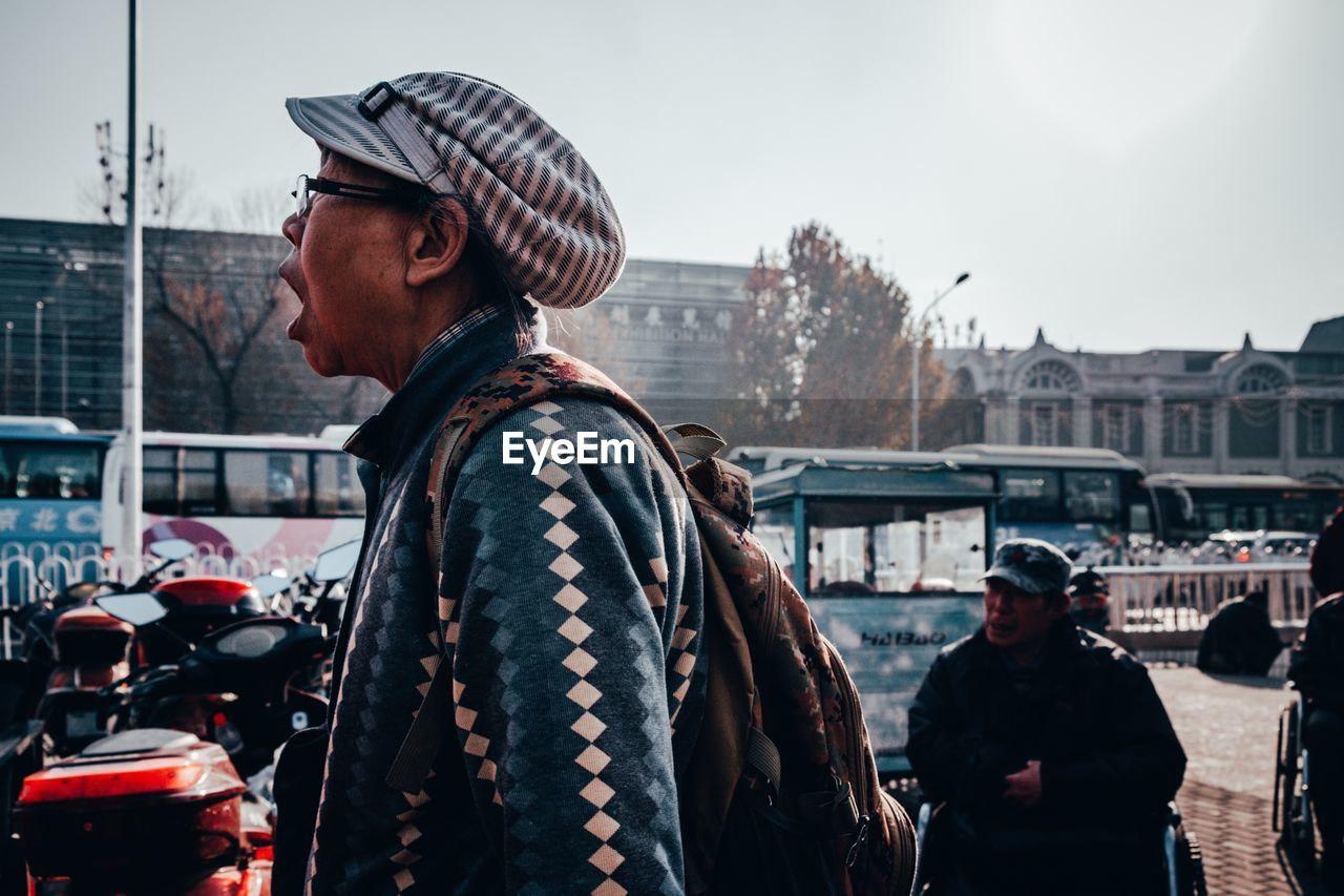 MAN STANDING ON DISPLAY IN CITY