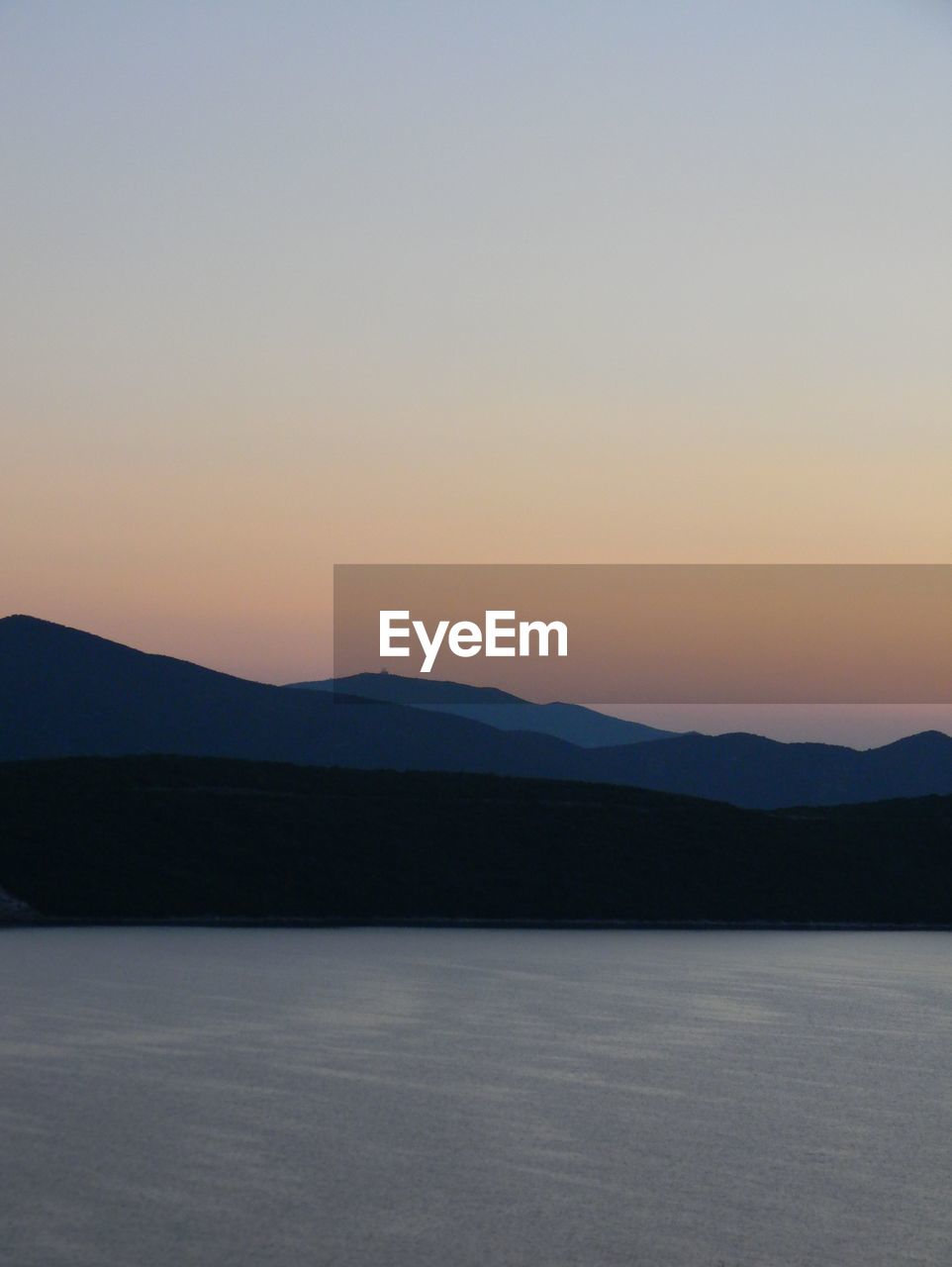 Scenic view of mountains against clear sky during sunset