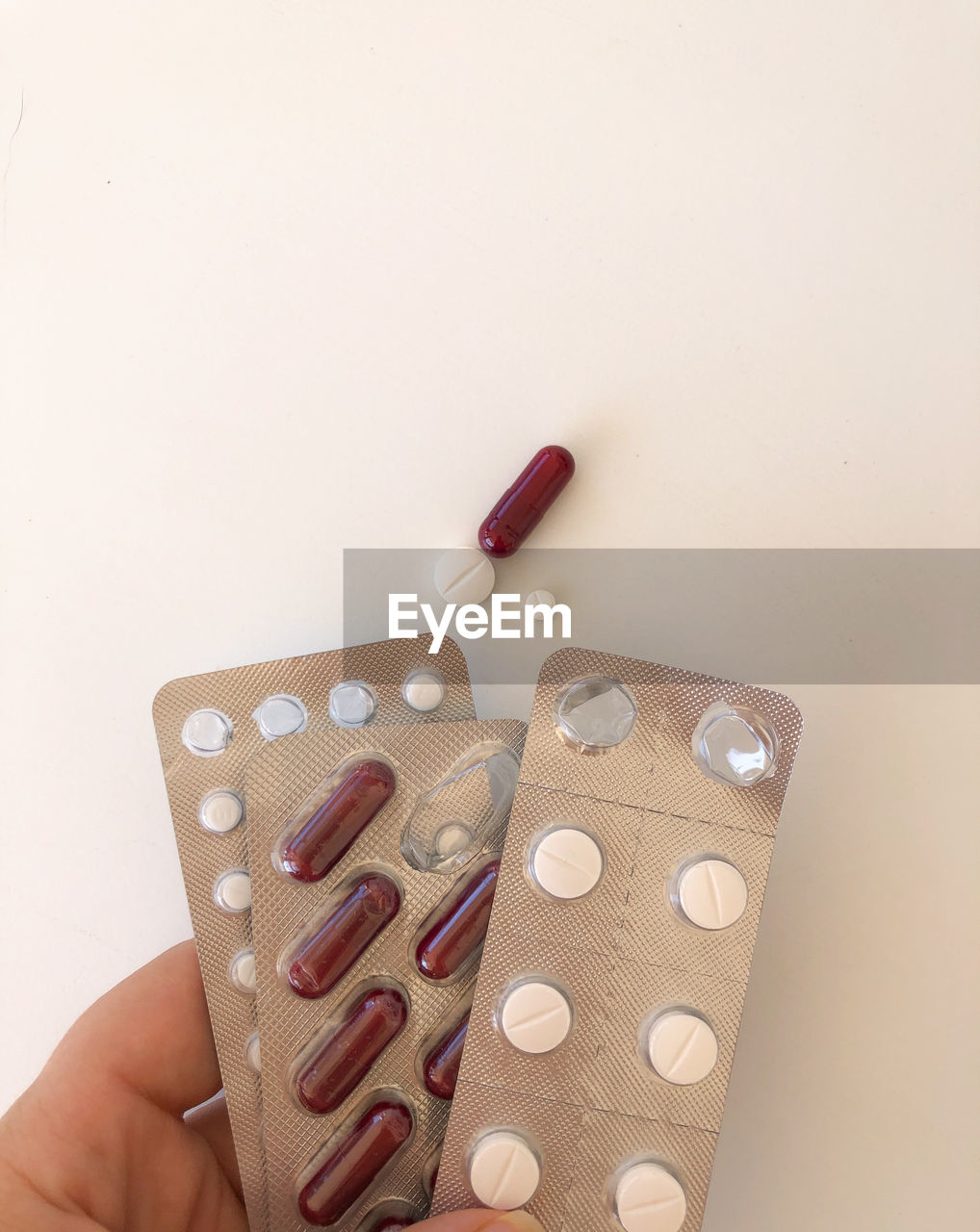 Different pharmaceutical medicine pills hold by hand