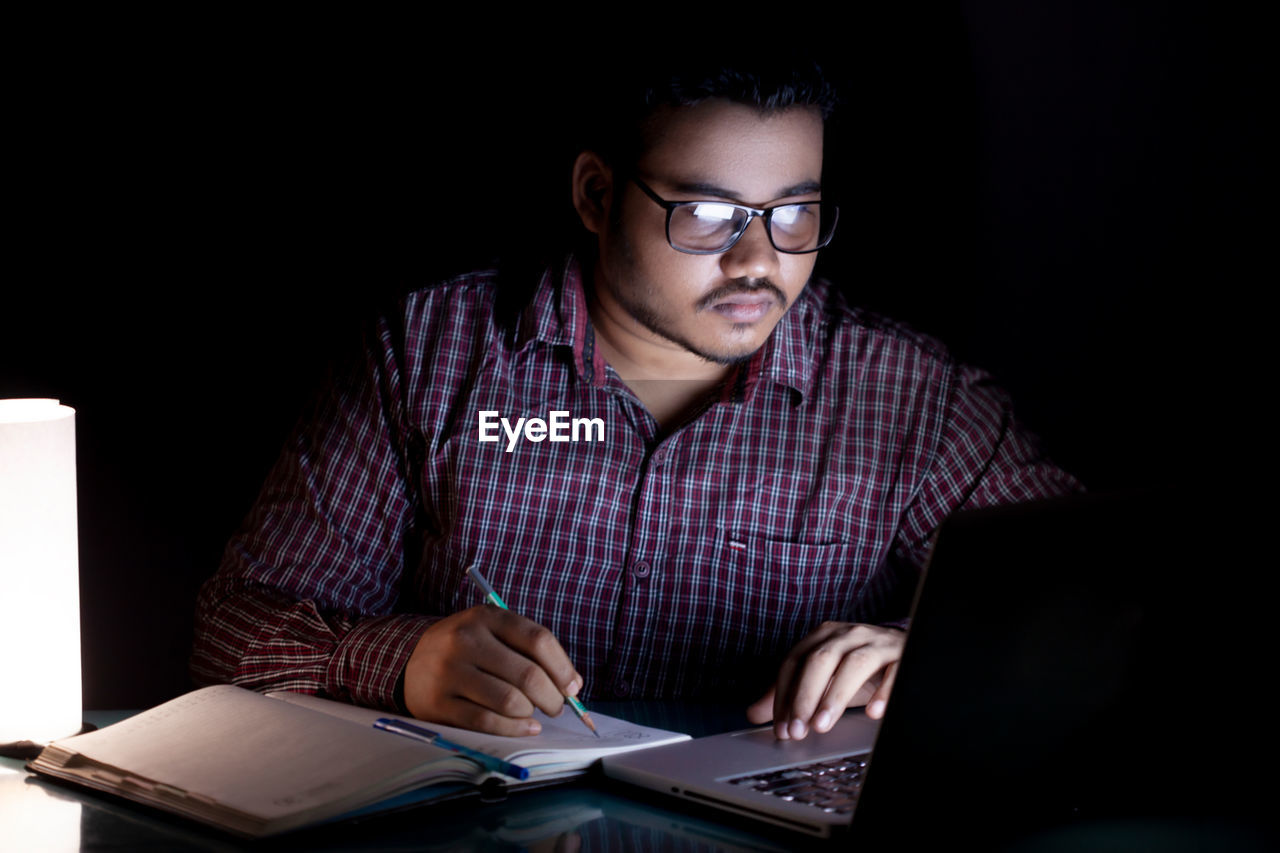 Business person working overtime at late night using computer